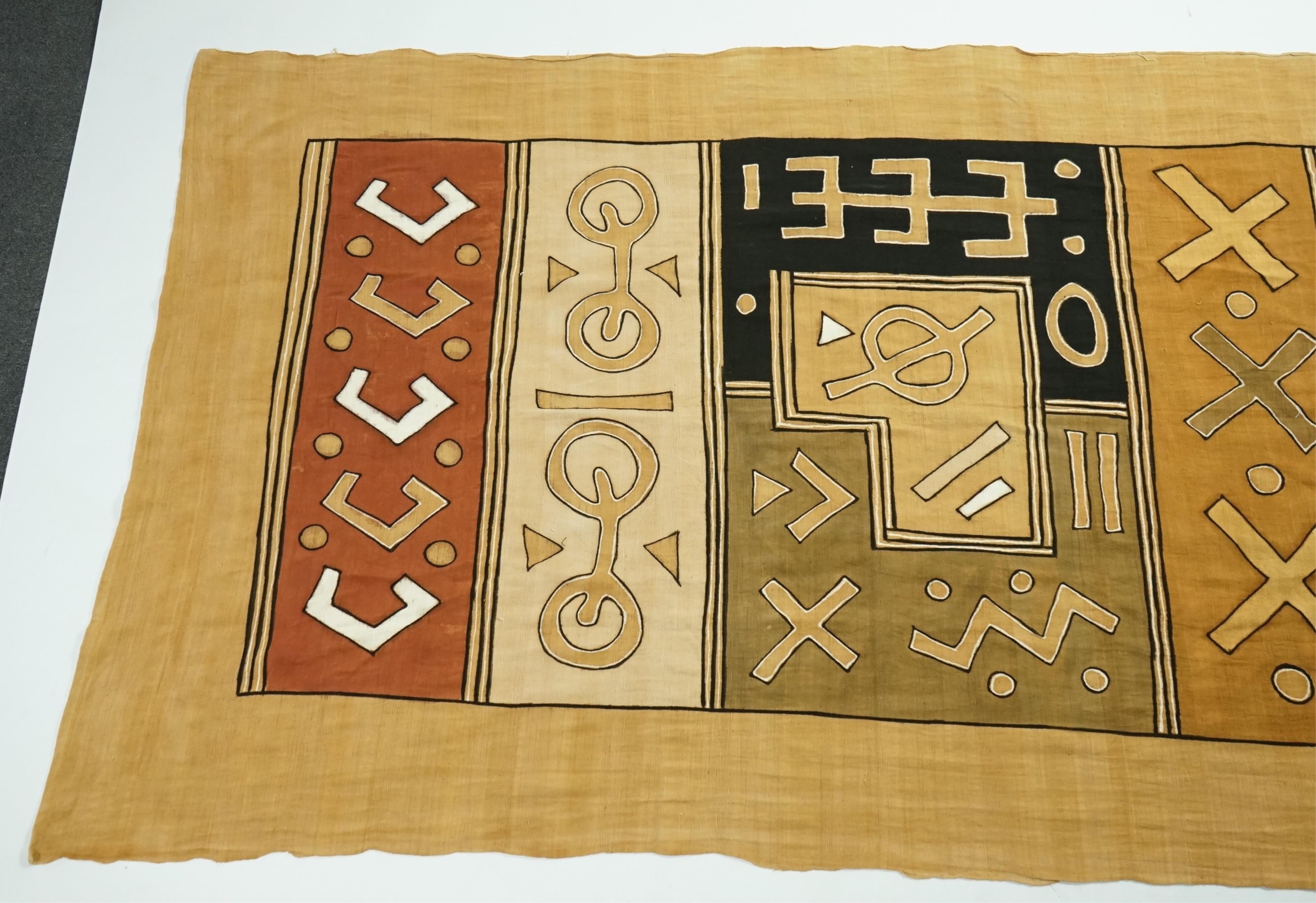 A collection of five 20th century African Congo hand woven and embroidered raffia palm leaf runners and mats, together with a later large printed hanging. 260cm x 138cm. Condition - one smaller mat has a hole in the weav